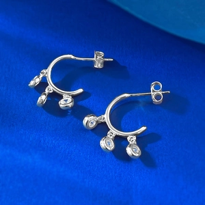 Close-up of S925 silver C-shaped hoop earrings with three dangling round zircons