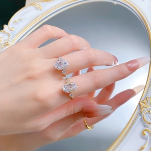 Close-up of elegant S925 sterling silver gold-plated oval cut solitaire rings on finger