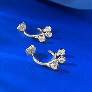 Macro shot of S925 sterling silver earrings with three claw-set cubic zirconia stones