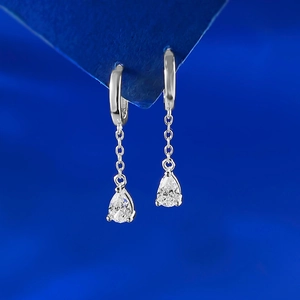 S925 silver pear-cut dangle earrings with tassels and sparkling clear stones on blue background