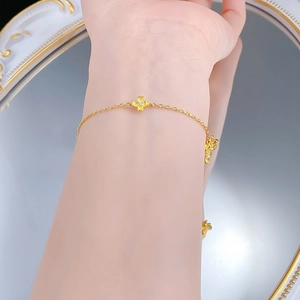 Detailed view of an S925 silver golden flower bracelet with zircon on a woman's wrist