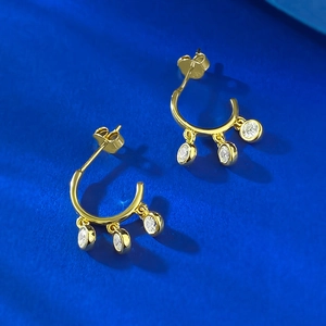 Detailed macro view of S925 hallmark on gold plated silver hoop earrings with white stones