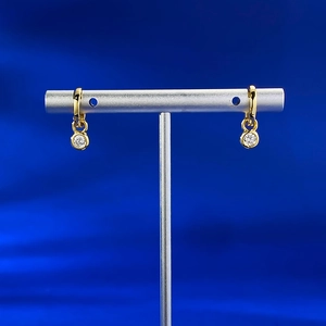 Detailed close-up of gold plated S925 silver bubble stud earrings with round cubic zirconia