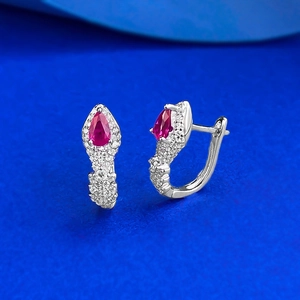 S925 sterling silver pear-shaped red zircon snake-style earrings on blue background