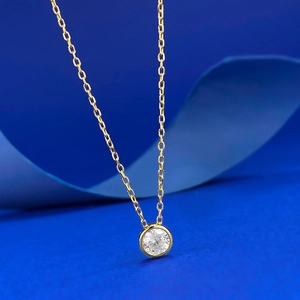 Classic gold S925 silver necklace with 5.0 white zircon pendant on blue textured paper