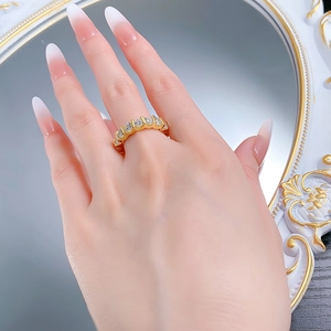 Macro detail of gold plated S925 silver ring featuring seven round white zircons