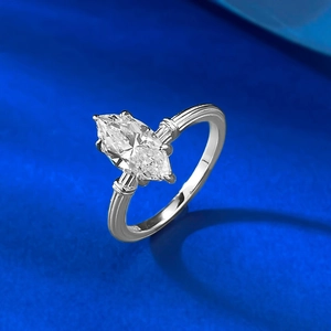 Macro view of marquise cut ring with vintage twisted silver band and side stones