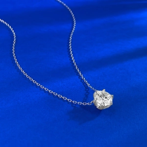 Macro shot of 9mm round brilliant cut stone with four-claw setting on silver chain