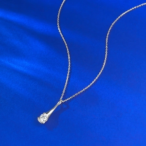 Detail of S925 silver necklace with sparkling waterdrop pendant and round zircon stone