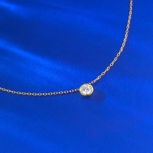Macro view of gold plated S925 silver necklace featuring a bezel-set white zircon stone