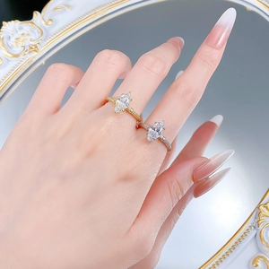 Vintage marquise-cut rings with textured bands in gold and silver finish on finger