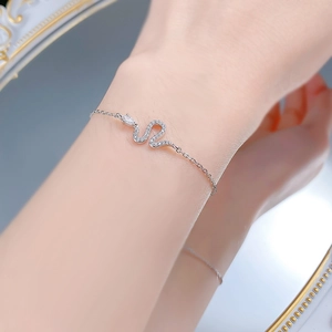 Elegant S925 silver snake bracelet with sparkling zircon stones worn on wrist