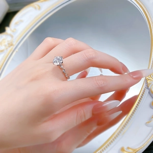 Macro detail of S925 silver ring with classic six-prong round zircon and twisted rope band
