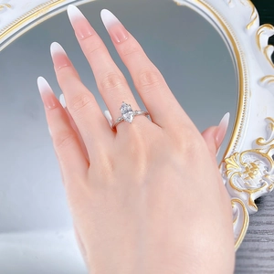 Detail of S925 silver marquise cut ring with vintage knot band worn by a model