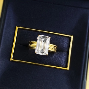 Close-up of S925 gold-plated ring with rectangular emerald-cut stone in velvet box