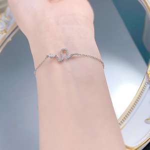 Detailed view of an S925 silver snake bracelet with cubic zirconia on a wrist