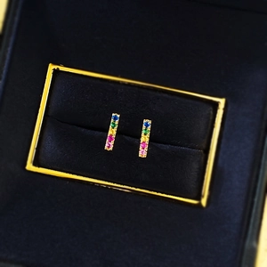 Macro shot of S925 silver rainbow gemstone stud earrings on black velvet jewelry box