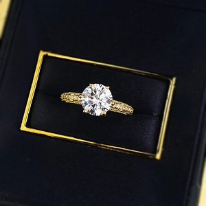 Macro shot of S925 gold-plated ring with large round diamond in black velvet box