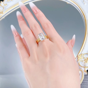 Macro shot of an 18K gold-plated multi-row ring featuring a large emerald-cut gemstone