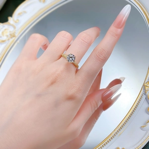 Close-up of S925 silver gold-plated ring with a large round white zircon on a model hand