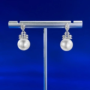 Detailed view of S925 silver 10mm pearl earrings with crystal-encrusted crown settings