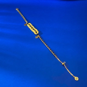 S925 silver gold-plated five coins bracelet with black cord on blue textured background