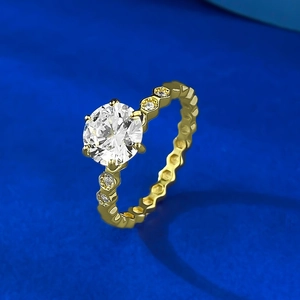Detail of gold six-prong round diamond ring featuring a unique honeycomb band design