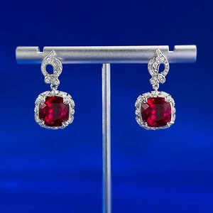 Close-up of S925 silver stud earrings with 10x10mm square red stones and pavé diamonds