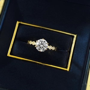 Classic gold six-prong round solitaire engagement ring with honeycomb diamond-set band