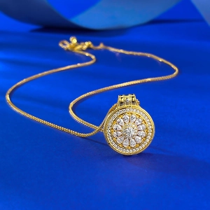Detailed close-up of golden S925 silver necklace with rotatable floral compass pendant