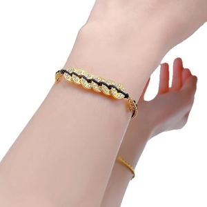 S925 silver coin gold chain bracelet with white zircons and black woven cord on wrist