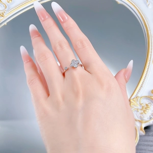 Detailed close-up of S925 silver clover ring with sparkling zircon stone on female finger