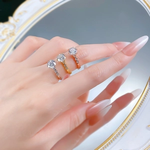 Detailed close-up of three hexagonal honeycomb stackable rings in gold, silver, and rose gold