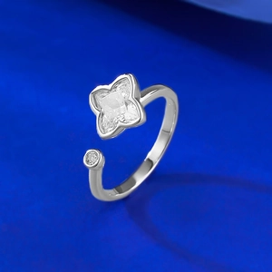 Detail of S925 silver clover ring featuring a square-cut zircon on blue background
