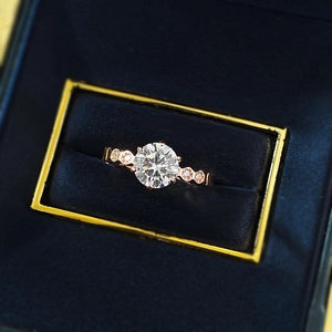Close-up of S925 silver six-prong round diamond ring in rose gold with velvet box