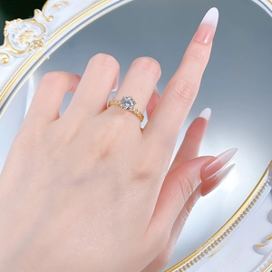 Classic six-prong gold ring with a brilliant round diamond on a model's hand