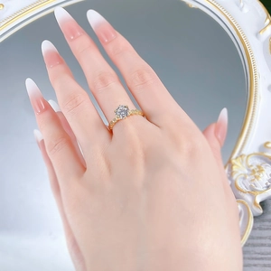 Detailed close-up of a 925 silver six-prong round diamond gold ring worn on a hand
