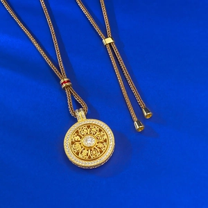Macro detail of rotating S925 silver compass pendant with intricate Eight Auspicious patterns