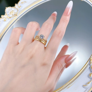 Close-up of a three-piece S925 silver gold ring set with a six-prong round diamond on a model