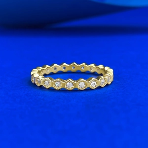 Macro shot of gold-plated honeycomb ring with full circle hexagon pavé cubic zirconia