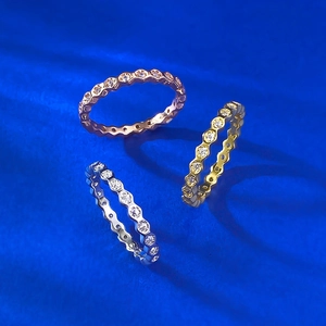 Three-color honeycomb stackable eternity rings with clear pavé stones on blue silk