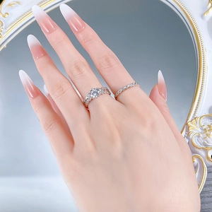 Detail of S925 silver six-prong round diamond wedding ring set worn on finger