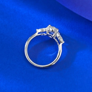 Elegant S925 sterling silver three-stone ring with a round center stone on blue background