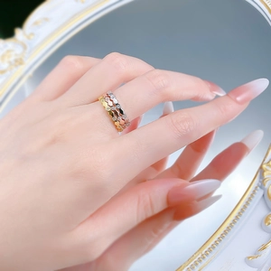Detailed view of three-tone S925 silver honeycomb rings with small diamonds on hand