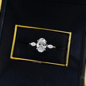 Close-up of S925 silver ring with oval and pear cut crystals in a black velvet box