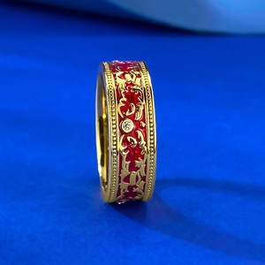 Detailed side view of vintage S925 silver ring with red enamel and gold floral engraving