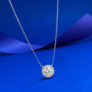 Elegant S925 silver necklace with 7mm round diamond pendant on a dark blue silk background