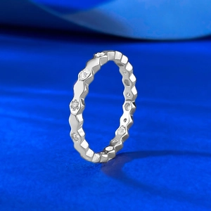 Macro detail of silver honeycomb ring showing hexagonal facets and micro-set cubic zirconia
