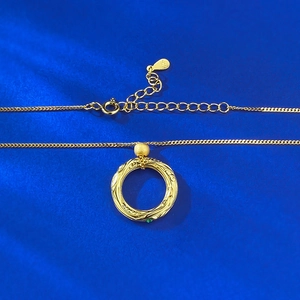 Gold S925 silver necklace with textured circular pendant and small green gemstone