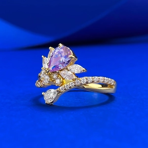 Elegant gold pear-cut purple gemstone ring with marquise diamonds on blue silk